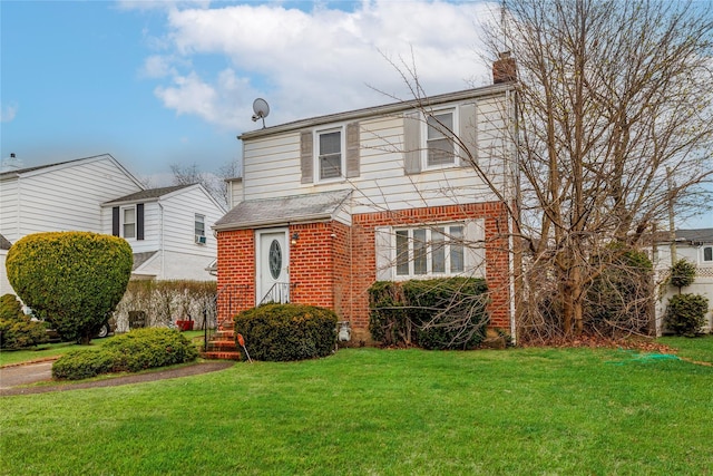 view of front facade with a front lawn, brick siding, and a chimney