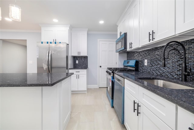 kitchen with stainless steel appliances, backsplash, a sink, crown molding, and white cabinetry