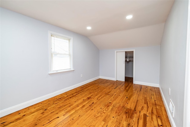 bonus room featuring recessed lighting, vaulted ceiling, light wood-style floors, and baseboards