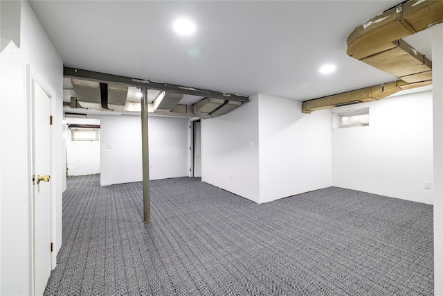 basement featuring dark colored carpet