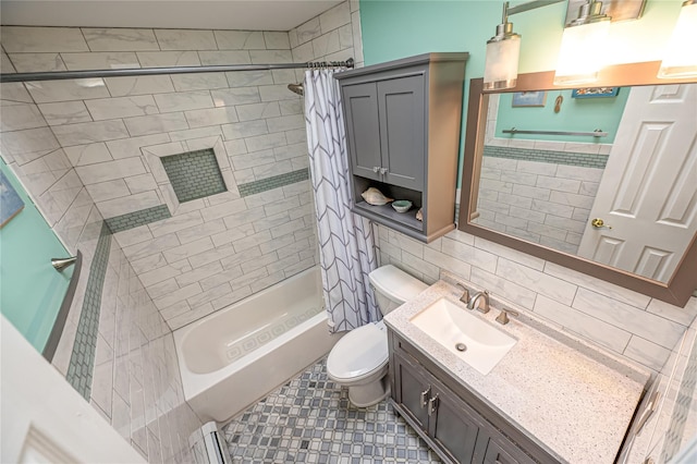 full bathroom with toilet, tile walls, shower / tub combo, and vanity