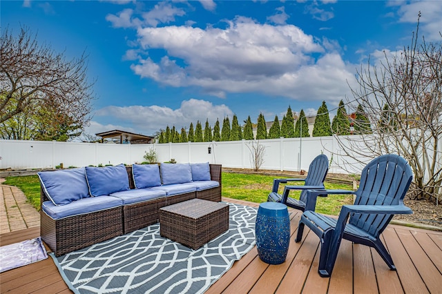 wooden terrace featuring a fenced backyard and an outdoor hangout area