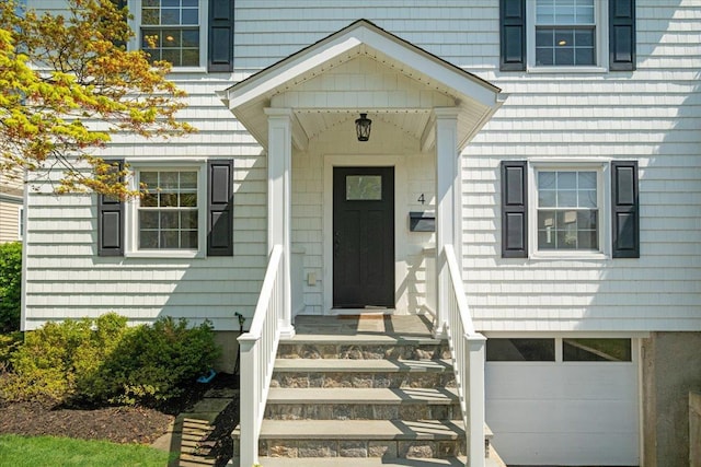 view of exterior entry with a garage