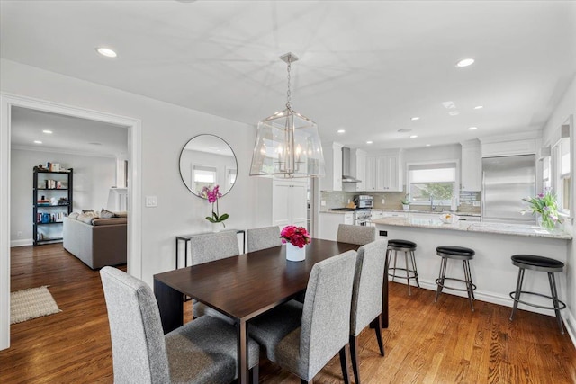 dining room with wood finished floors and recessed lighting