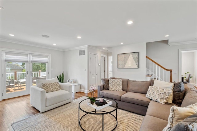 living area featuring light wood finished floors, stairs, visible vents, and recessed lighting