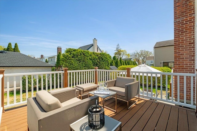 wooden terrace with outdoor lounge area