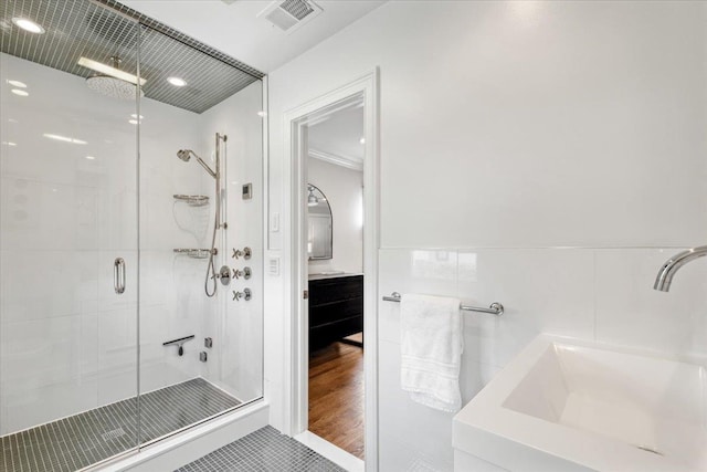 bathroom with a sink, visible vents, a stall shower, recessed lighting, and tile patterned floors