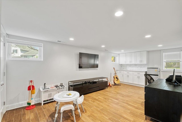 interior space featuring light wood finished floors, recessed lighting, visible vents, and a healthy amount of sunlight