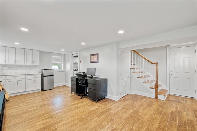home office with light wood finished floors, recessed lighting, and baseboards