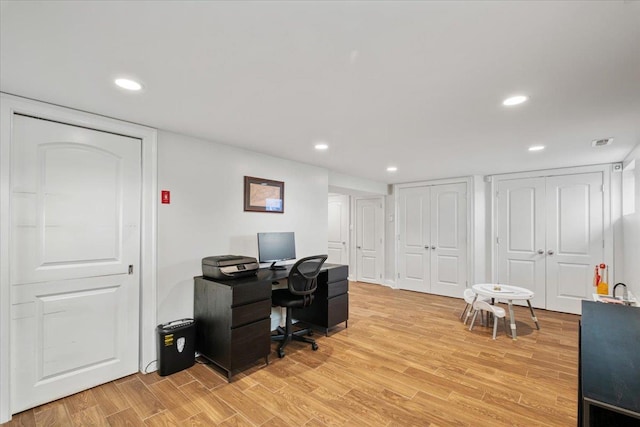 office space featuring visible vents, recessed lighting, and light wood-style flooring
