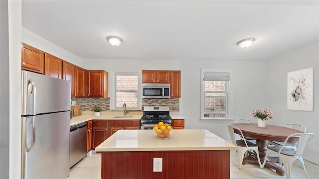 1813 Edenwald Ave, Bronx, NY 10466 - kitchen featuring a sink, decorative backsplash, appliances with stainless steel finishes, light countertops, and light tile patterned floors
