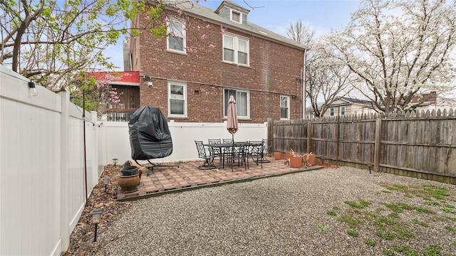 1813 Edenwald Ave, Bronx, NY 10466 - rear view of house with a fenced backyard, brick siding, and a patio