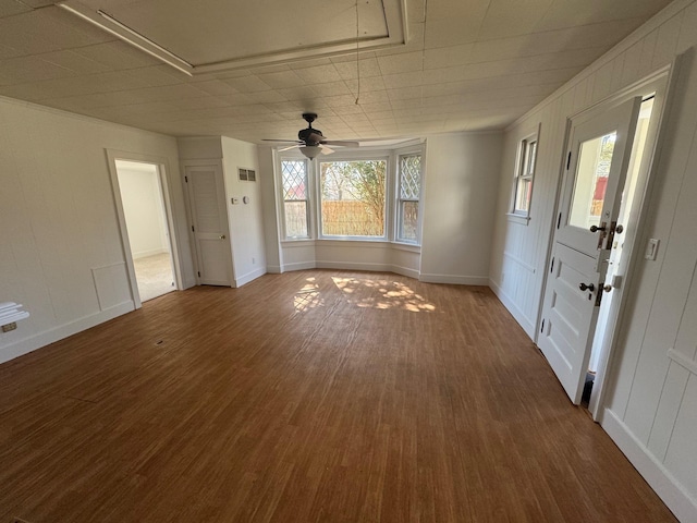 1845 Shipyard Ln, East Marion, NY 11939 - unfurnished living room featuring attic access, dark wood-style flooring, a ceiling fan, and baseboards