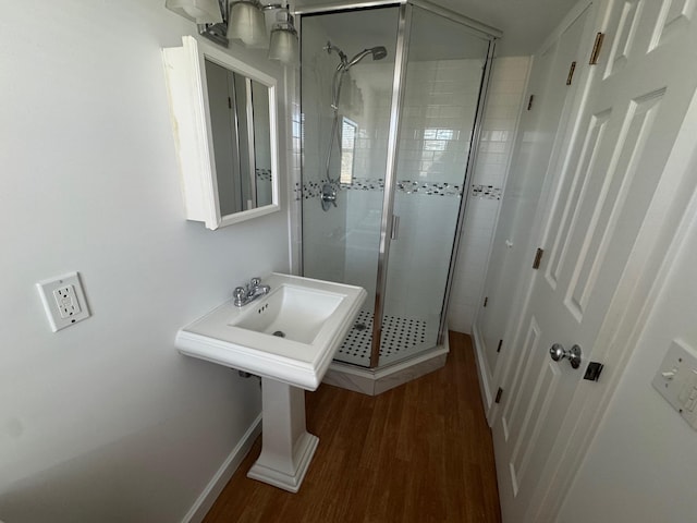 1845 Shipyard Ln, East Marion, NY 11939 - bathroom featuring a shower stall, wood finished floors, and baseboards