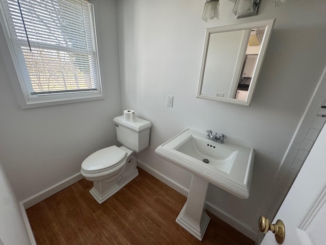 1845 Shipyard Ln, East Marion, NY 11939 - half bath with toilet, wood finished floors, and baseboards