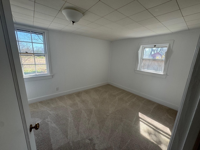 1845 Shipyard Ln, East Marion, NY 11939 - carpeted empty room featuring healthy amount of natural light, baseboards, and a drop ceiling