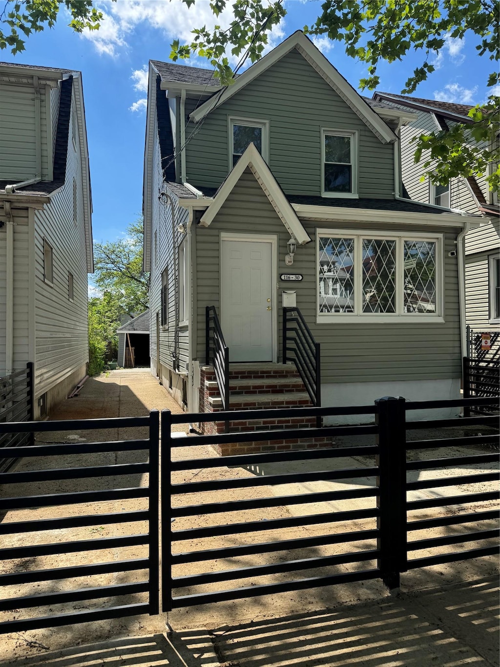 116-30 130th St, South Ozone Park, NY 11420 - view of front of house featuring entry steps and a fenced front yard