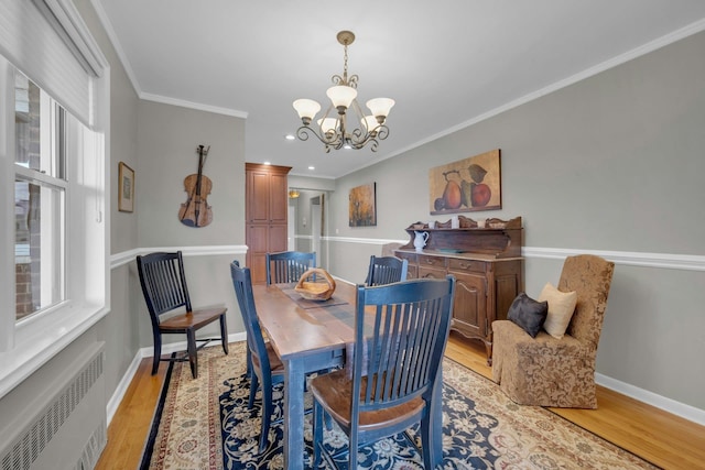 1255 N Ave Unit B-4L, New Rochelle, NY 10804 - dining room featuring crown molding, a notable chandelier, light wood-style floors, radiator heating unit, and baseboards