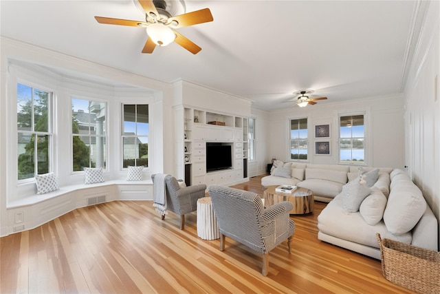 127 Senix Ave, Center Moriches, NY 11934 - living room featuring crown molding, a ceiling fan, visible vents, and light wood-style floors