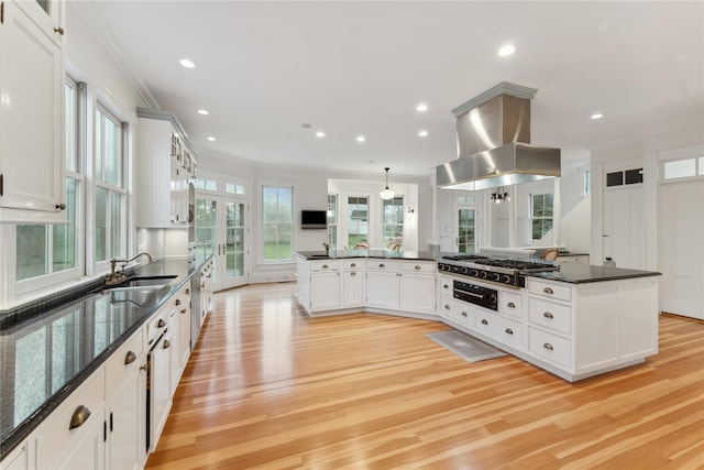 127 Senix Ave, Center Moriches, NY 11934 - kitchen featuring crown molding, light wood-style floors, stainless steel gas cooktop, and island range hood