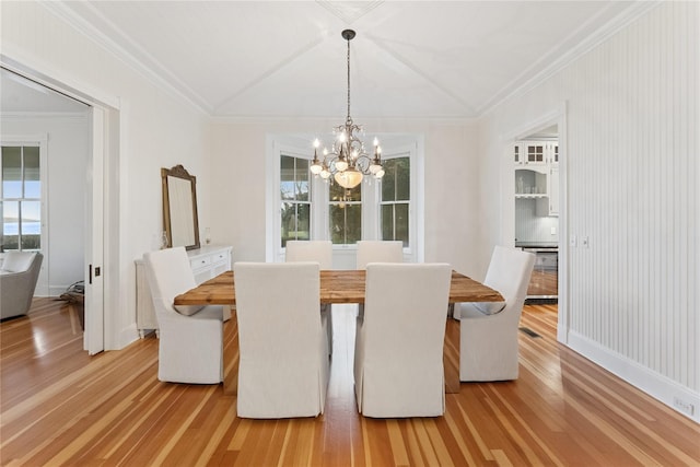 127 Senix Ave, Center Moriches, NY 11934 - unfurnished dining area with crown molding, baseboards, a notable chandelier, and light wood finished floors