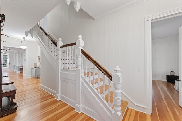 127 Senix Ave, Center Moriches, NY 11934 - staircase with ornamental molding, a decorative wall, and wood finished floors