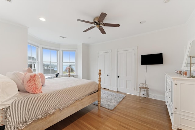 127 Senix Ave, Center Moriches, NY 11934 - bedroom with crown molding, two closets, and light wood finished floors