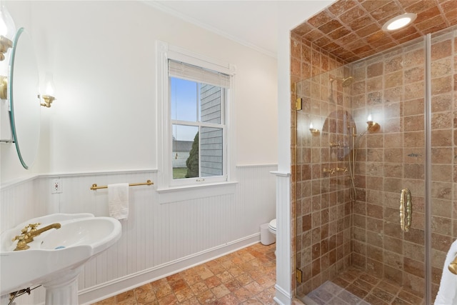 127 Senix Ave, Center Moriches, NY 11934 - bathroom with wainscoting, a sink, toilet, a shower stall, and ornamental molding