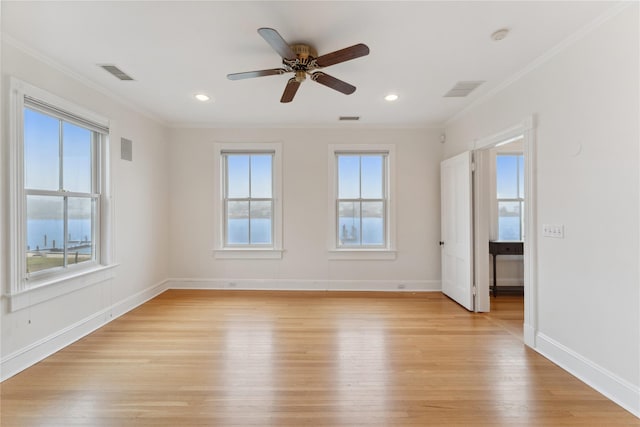 127 Senix Ave, Center Moriches, NY 11934 - unfurnished room with visible vents, crown molding, a wealth of natural light, and light wood-type flooring