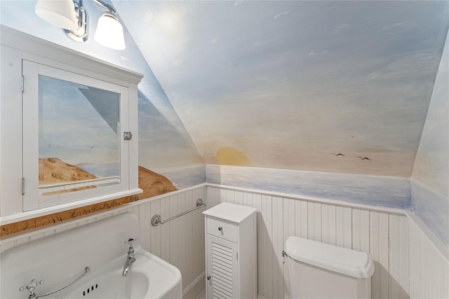 127 Senix Ave, Center Moriches, NY 11934 - bathroom with toilet, lofted ceiling, and a wainscoted wall