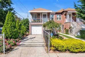 1103 Rhinelander Ave, Bronx, NY 10461 - view of front of house featuring an attached garage, driveway, stairs, and a balcony