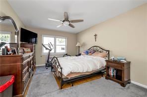 1103 Rhinelander Ave, Bronx, NY 10461 - bedroom with a ceiling fan and baseboards