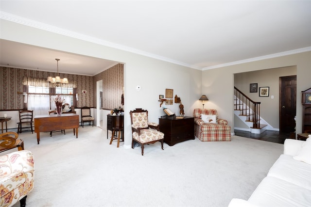 carpeted living area featuring crown molding, a notable chandelier, and stairs