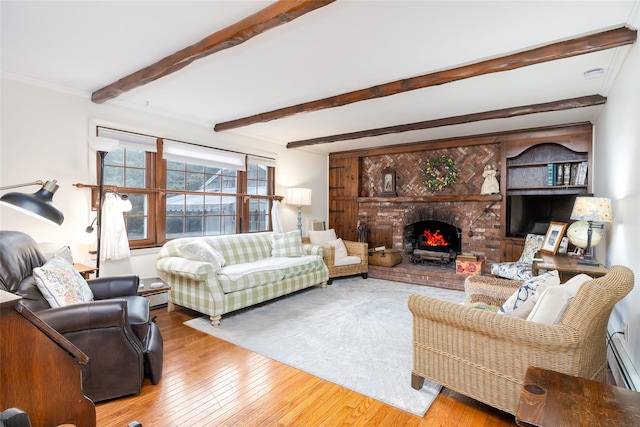 living area with crown molding, a fireplace, a baseboard radiator, beamed ceiling, and hardwood / wood-style flooring