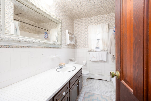 bathroom featuring wainscoting, toilet, baseboard heating, wallpapered walls, and tile patterned floors