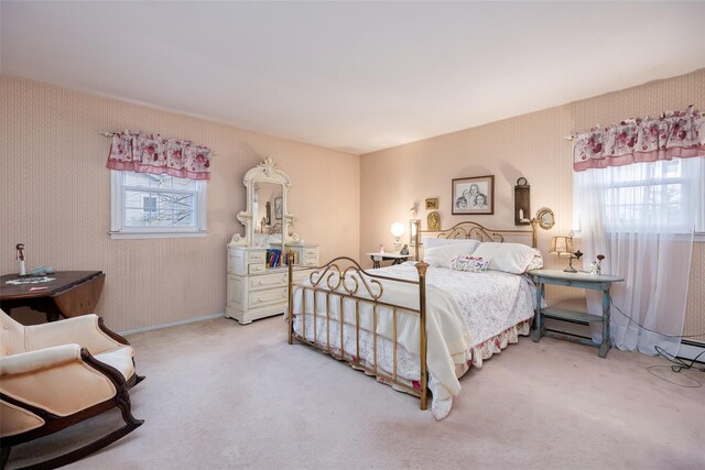 carpeted bedroom featuring baseboard heating