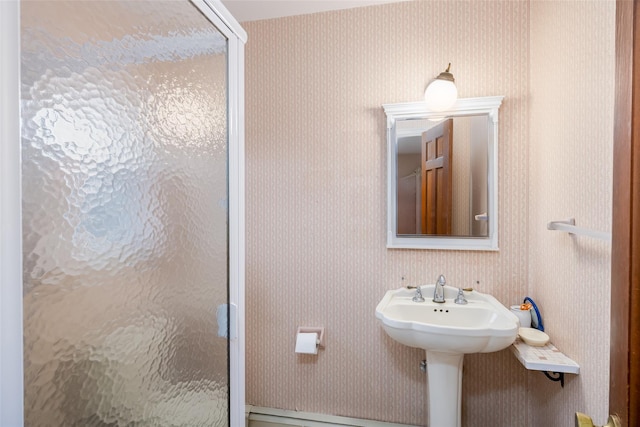 bathroom with a stall shower and wallpapered walls