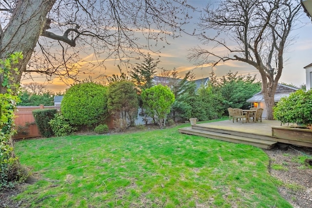 view of yard featuring a deck and fence