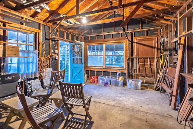misc room featuring vaulted ceiling and concrete flooring