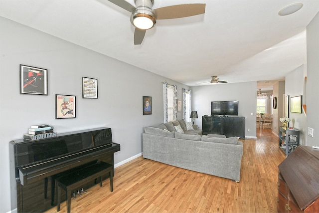 209 Pleasant Dr, Bay Shore, NY 11706 - living room with light wood-style floors, a ceiling fan, and baseboards
