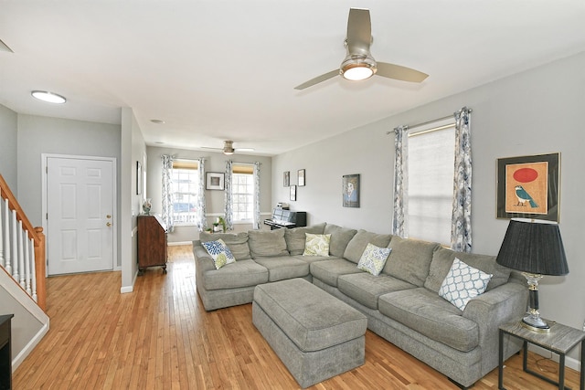 209 Pleasant Dr, Bay Shore, NY 11706 - living room with stairs, baseboards, light wood-style floors, and ceiling fan