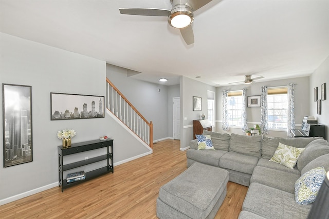 209 Pleasant Dr, Bay Shore, NY 11706 - living room with stairway, ceiling fan, baseboards, and light wood-style flooring