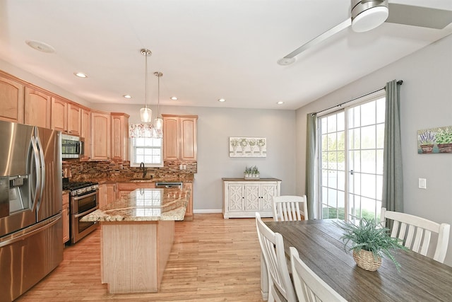 209 Pleasant Dr, Bay Shore, NY 11706 - kitchen with light brown cabinetry, a sink, light stone countertops, decorative backsplash, and appliances with stainless steel finishes