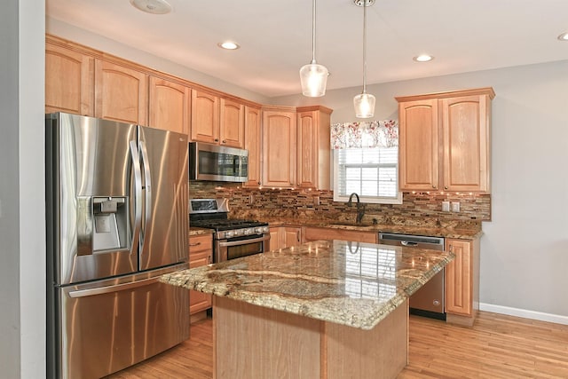 209 Pleasant Dr, Bay Shore, NY 11706 - kitchen featuring light brown cabinets, a sink, backsplash, appliances with stainless steel finishes, and light stone countertops