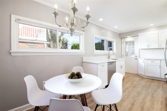 dining space featuring recessed lighting, an inviting chandelier, crown molding, and light wood-type flooring