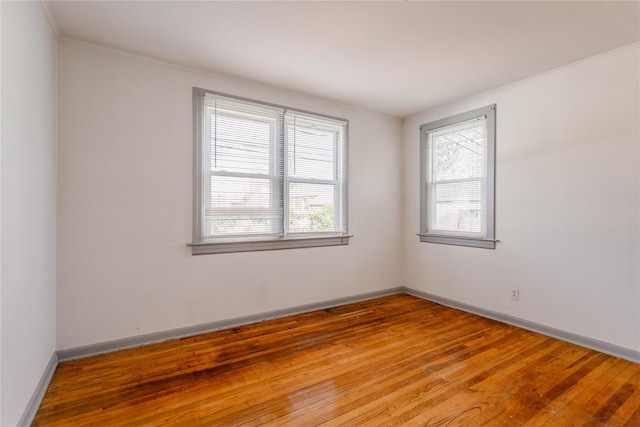 32-12 208th St, Bayside, NY 11361 - empty room with light wood-style floors, crown molding, and baseboards
