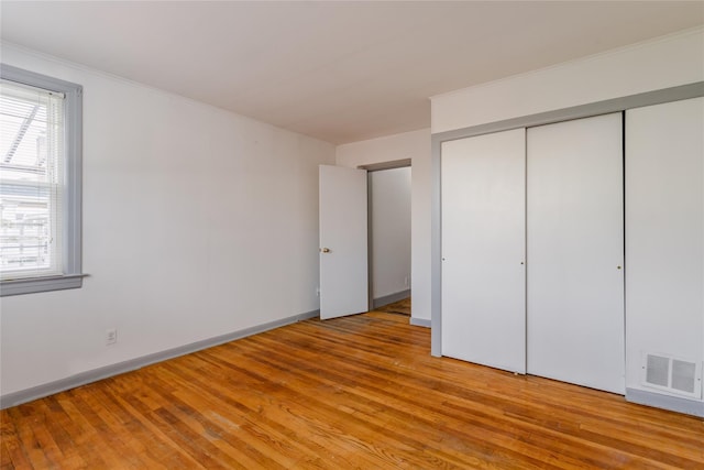 32-12 208th St, Bayside, NY 11361 - unfurnished bedroom featuring a closet, light wood-type flooring, visible vents, and baseboards