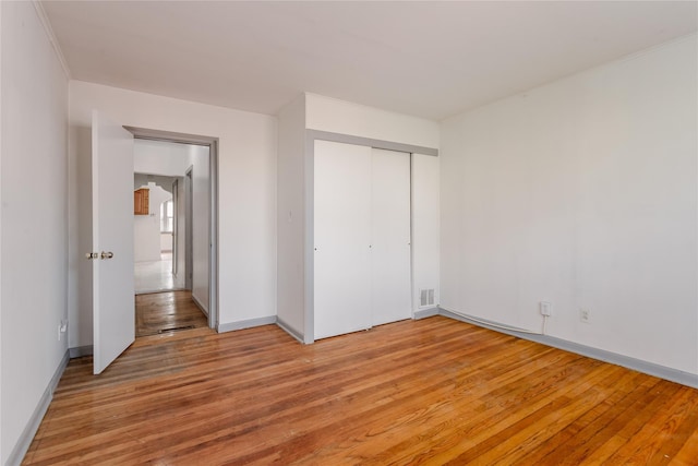 32-12 208th St, Bayside, NY 11361 - unfurnished bedroom featuring a closet, visible vents, light wood finished floors, and baseboards