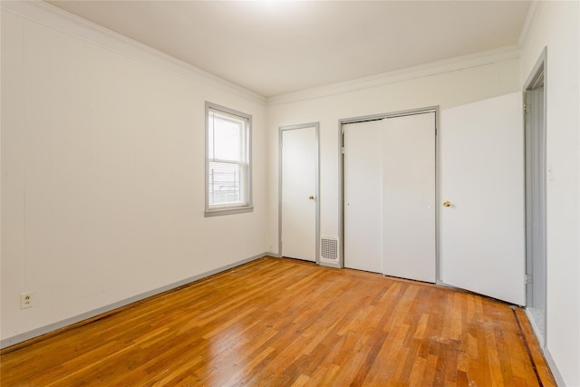 32-12 208th St, Bayside, NY 11361 - unfurnished bedroom featuring ornamental molding, light wood finished floors, and visible vents