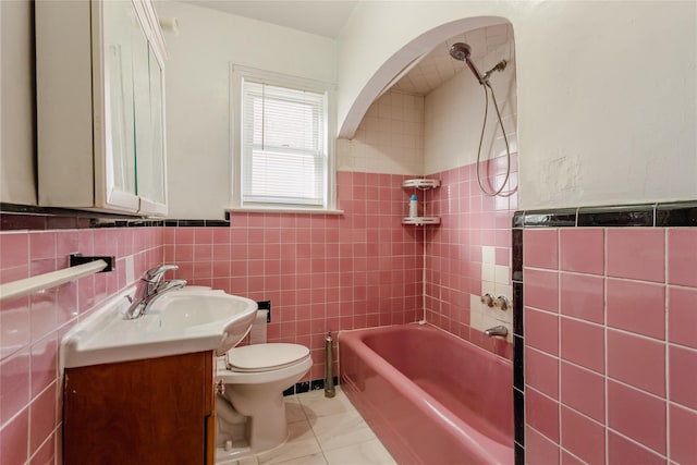 32-12 208th St, Bayside, NY 11361 - bathroom featuring vanity, tile walls, a wainscoted wall, toilet, and bathing tub / shower combination